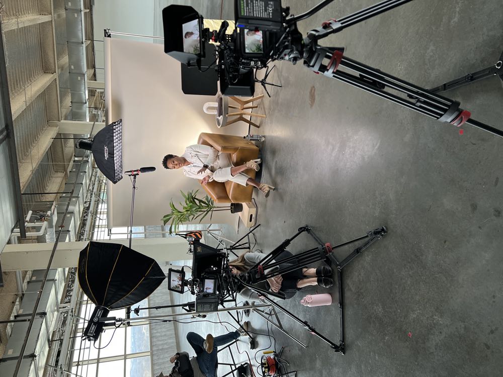 Filming an on-camera interview in an office lobby in Tulsa