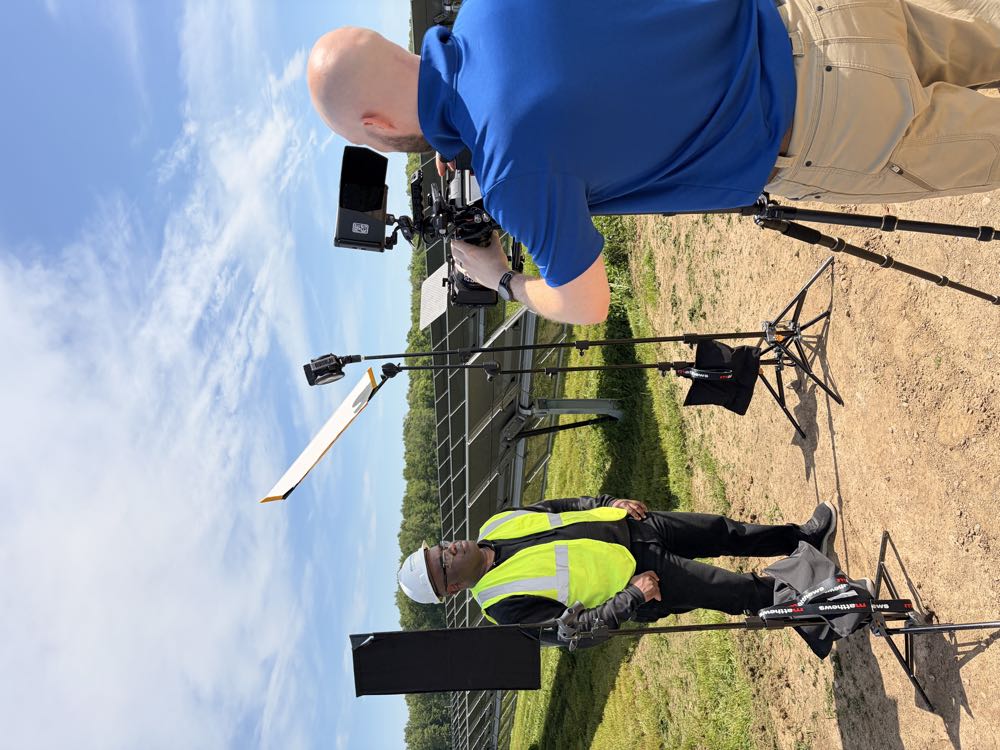 Interviewing a technician on location at a solar installation