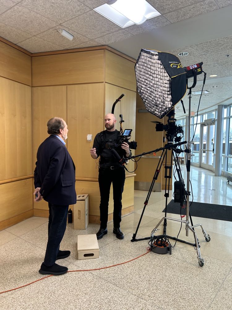 Filming a seated interview on a white cyclorama