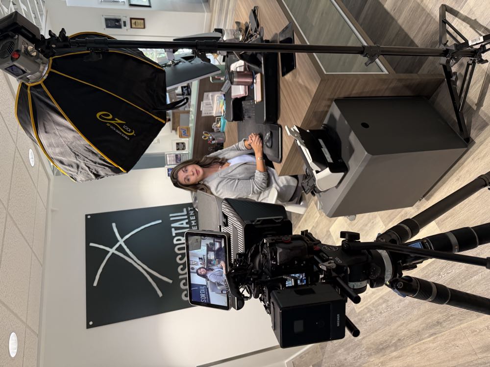 Filming an interview at a client's office desk
